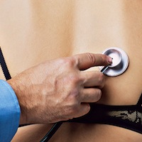 A doctor places a stethoscope on a patient's back. Used to illustrate sense of touch.